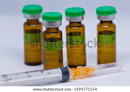 syringe and vials of injectable drugs - brown