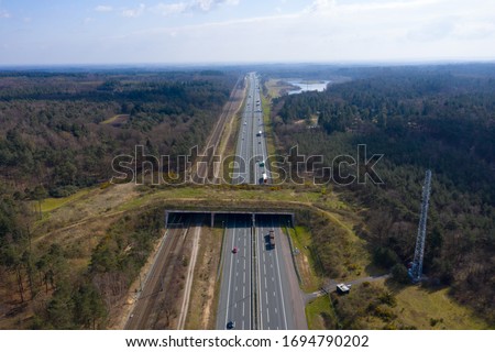 drone / aerial footage of a Wildlife / animal crossing over a dutch highway with lots of traffic. animal protection initiative. Royalty-Free Stock Photo #1694790202