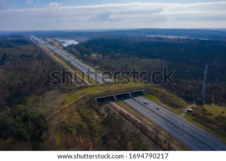 drone / aerial footage of a Wildlife / animal crossing over a dutch highway with lots of traffic. animal protection initiative. Royalty-Free Stock Photo #1694790217