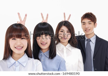 group of business people looking at camera with smiles and showing sign of victory