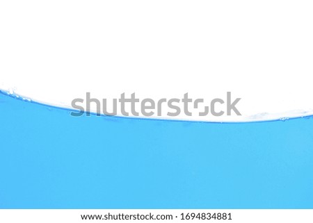 Close up water splash with air bubbles. Fresh and clean surface aqua flowing in wave and clean water on white background isolated. Advertising image with free space for your work  
