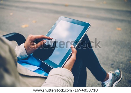 Digital tablet with copy space area for web internet advertising text, cropped view of female millennial checking received email while creating social publication during networking on modern touch pad
