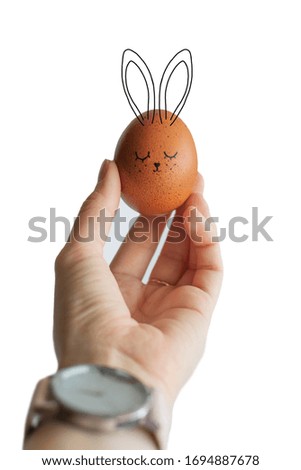 Easter egg in hand on a white background