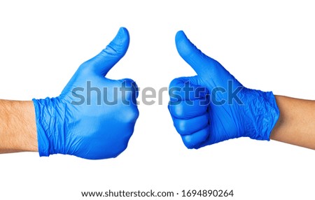 Two Hands in blue gloves isolated on white with thumb up, close up