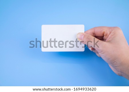 Holding a white card on a blue background