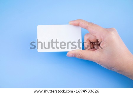 Holding a white card on a blue background