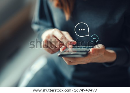 Women's hand typing on mobile smartphone, Live Chat Chatting on application Communication Digital Web and social network Concept. Work from home. Royalty-Free Stock Photo #1694949499