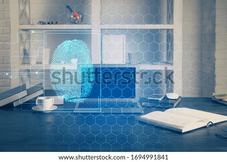 Computer on desktop in office with finger print drawing. Double exposure. Concept of business data security.
