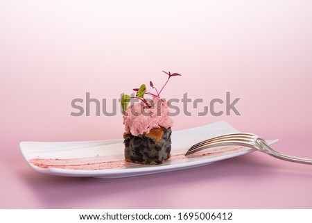 Carrot cake with whipped cream and sprouted seeds on a pink background