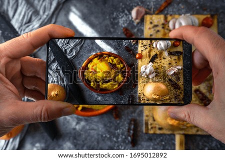 Man's hands taking a picture of a food preparation