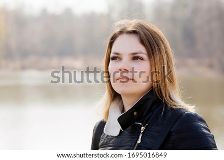 Portrait of a young girl by the river