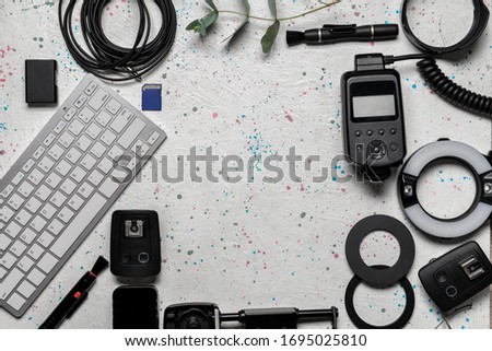 Frame made of modern photographer's equipment and computer keyboard on white background