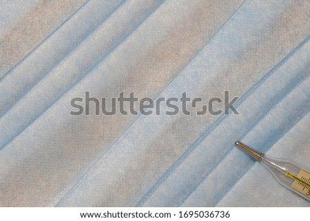 medical health care simple background of soft blue pastel color fabric texture and thermometer diagnostic object in corner, empty copy space for your text here 