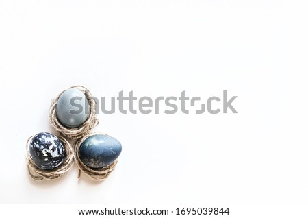 Pastel composition for the holiday of Easter. Colored eggs in natural colors. Background for the presentation of work or text.