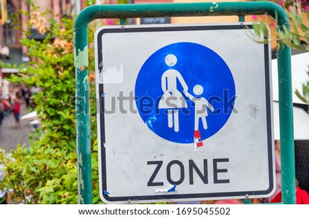 Pedestrian zone sign in front of no traffic area.