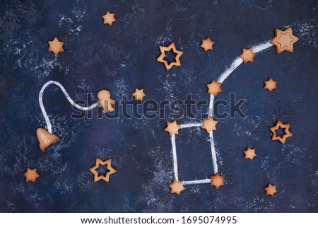Homemade Flying Cookies in form rocket, stars and astronaut for world cosmonautics day. the constellation URSA minor from cookies and flou Royalty-Free Stock Photo #1695074995