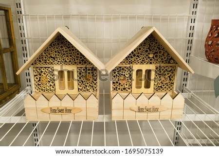 Hotel house for insects with text Home Sweet Home in the store. Garden shelter for wild insects
