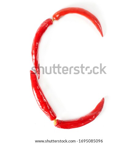 Letter C made from red hot chili peppers. Isolated on white background