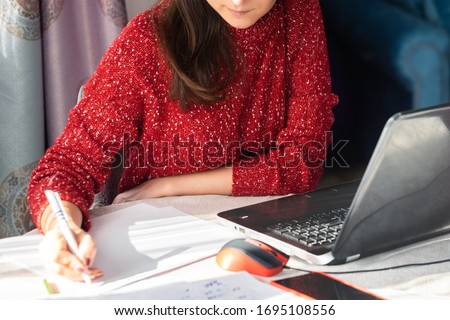 Young woman using personal laptop for freelance job, online education, training, blogging or online shopping. Confident female person working from home. Mobile technology in modern world concept.  Royalty-Free Stock Photo #1695108556