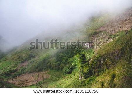 Foggy hills with clouds in the background at Osmena Peak, Cebu, Philippines
