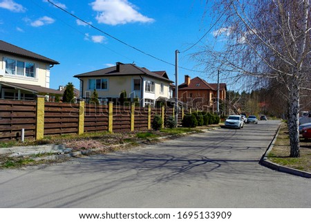 The street of new houses of two-storeyed, building . Spring sunny day .