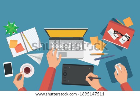 Flat vector illustration of graphics or illustrators workplace with laptop, graphic tablet, notebooks and books and coffee - home office, work process