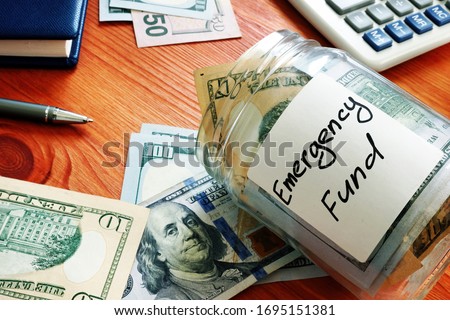 Emergency fund in the glass jar with cash. Royalty-Free Stock Photo #1695151381