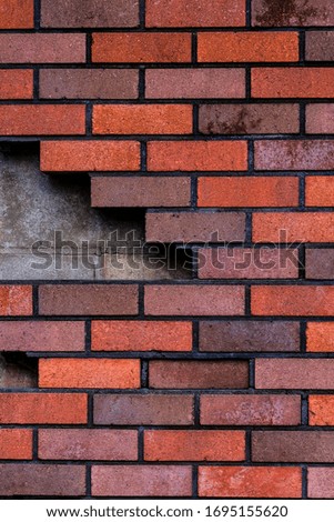 Red and grey brick wall texture background. Beautiful new concrete blocks layout. Modern construction. Vertical, close up	