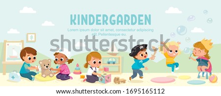 Kids play together in kindergarden. Playroom with children.