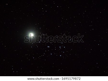 Venus and the Pleiades.  Once every eight years, the Pleiades, (also known as the Seven Sisters) star cluster and Venus appear very close in the sky when in reality they are not. 