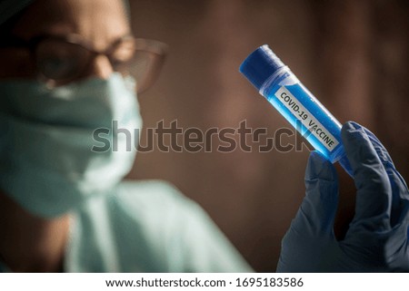 Conceptual image of a nurse holding a recipient with the coronavirus COVID-19 vaccine.