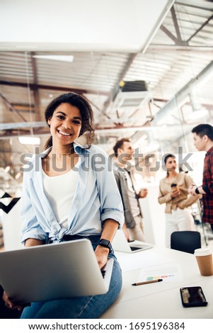 Charming young woman holding modern notebook and smiling stock photo