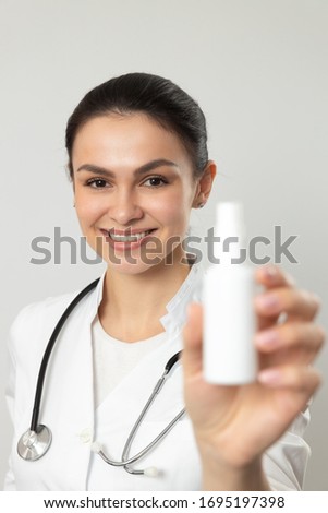Female smiling pediatrician posing for camera in hospital stock photo. Pediatrics concept
