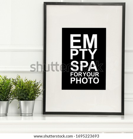 Table background of free space and photo frame of free space for your decoration.Spring sunny day and white wall. 