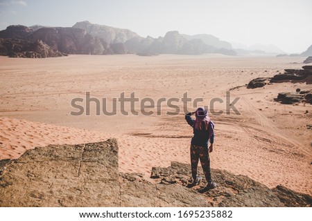 woman looking on desert moody dramatic dry landscape in smoke from cliff edge top view point, climate changes global warming ecology photography concept   