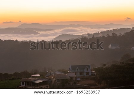 Beautiful landscape of mountain misty morning sunrise at Dalat city, Vietnam.