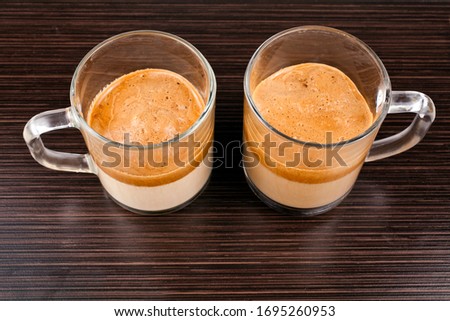 Two glass cups of whipped dalgona coffee. Top view.