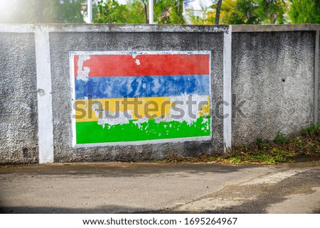 Mauritius flag pictured on a city wall. Travel and holiday concept.