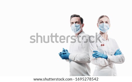 doctors man and woman on a white background in medical masks on the face Royalty-Free Stock Photo #1695278542