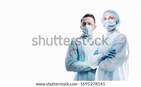 doctors man and woman on a white background in medical masks on the face Royalty-Free Stock Photo #1695278545