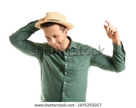 Cool young man dancing against white background