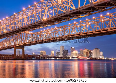 New Orleans, Louisiana, USA at Crescent City Connection Bridge over the Mississippi River at night.