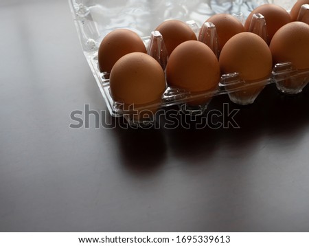 Chicken eggs stock at home, isolate wooden dark background with copy space.