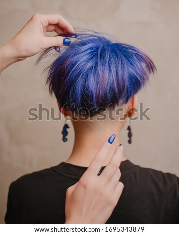 Girl with blue hair at the hairdresser. Color bright coloring