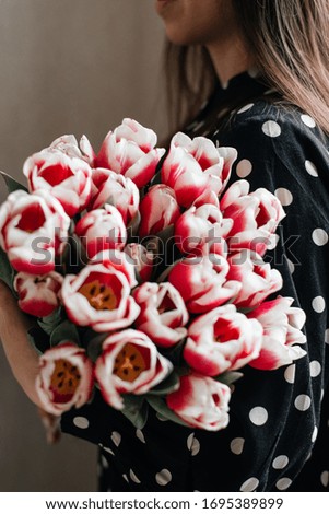 Young girl holding a wonderful bouquet tulips in their hands. Spring bouquet. Spring concept.  