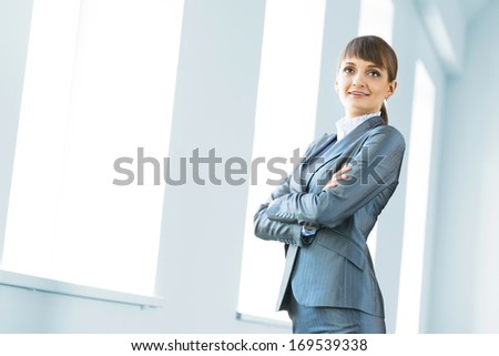 young modern business woman, crossed her arms and smiles