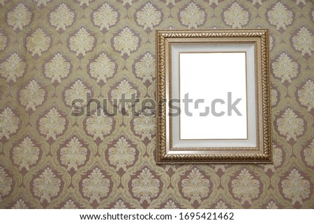 Empty picture frame Over vintage wallpaper background