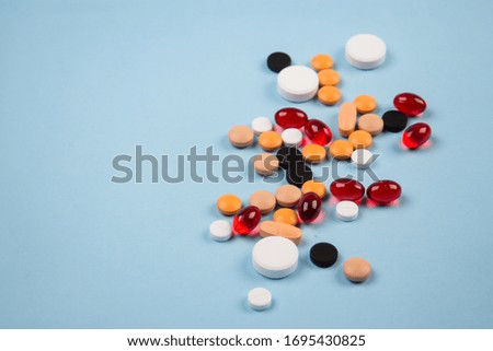 pills of different colors on a blue background