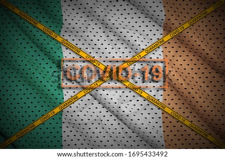 Ireland flag and Covid-19 stamp with orange quarantine border tape cross. Coronavirus or 2019-nCov virus concept