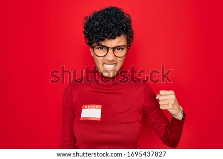 Young beautiful african american afro woman using sticker with presentation message annoyed and frustrated shouting with anger, crazy and yelling with raised hand, anger concept